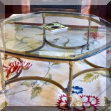F05. Glass and brass octagonal coffee table. 15”h x 39”w 